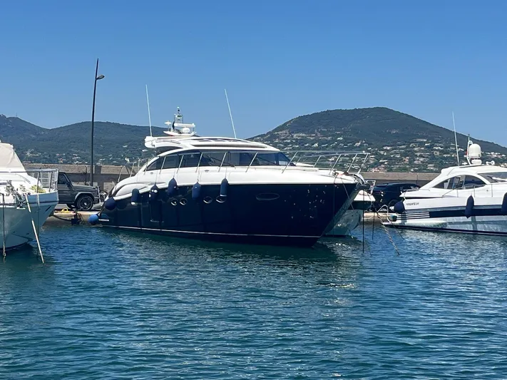  Yacht Photos Pics Luxurious 2011 Princess V62 yacht docked in a scenic marina setting.