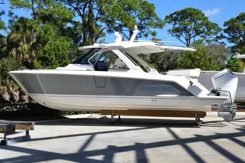 Diamond Pearl Yacht Photos Pics 2024 Tiara Yachts 38 LS boat, "Diamond Pearl," displayed outdoors with lush greenery.