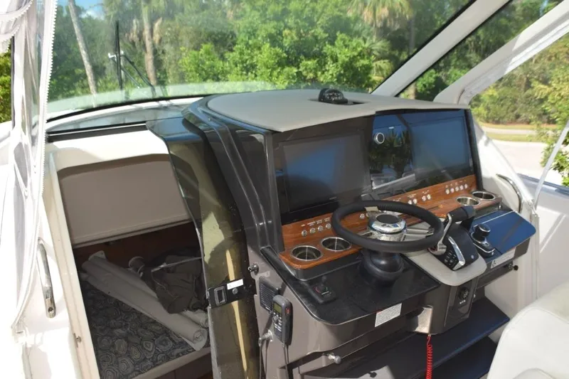 Diamond Pearl Yacht Photos Pics 2024 Tiara Yachts 38 LS helm with modern controls and dual Garmin screens. Cabin entry door open.