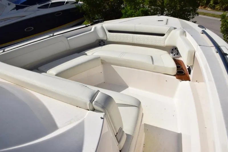 Diamond Pearl Yacht Photos Pics 2024 Tiara Yachts 38 LS bow area with white seating, drink holders, and safety grab railings.