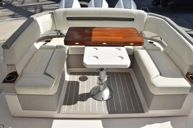 Diamond Pearl Yacht Photos Pics 2024 Tiara Yachts 38 LS cockpit with seating, wood tabletop which folds open or can be lowered to make sunbed.