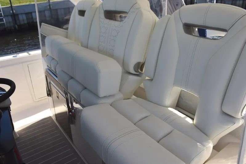 Diamond Pearl Yacht Photos Pics 2024 Tiara Yachts 38 LS, triple helm chairs, fold-up standing bolsters, fold down armrests. Electric adjustable center, drink refrigerator beneath starboard side, footrests
