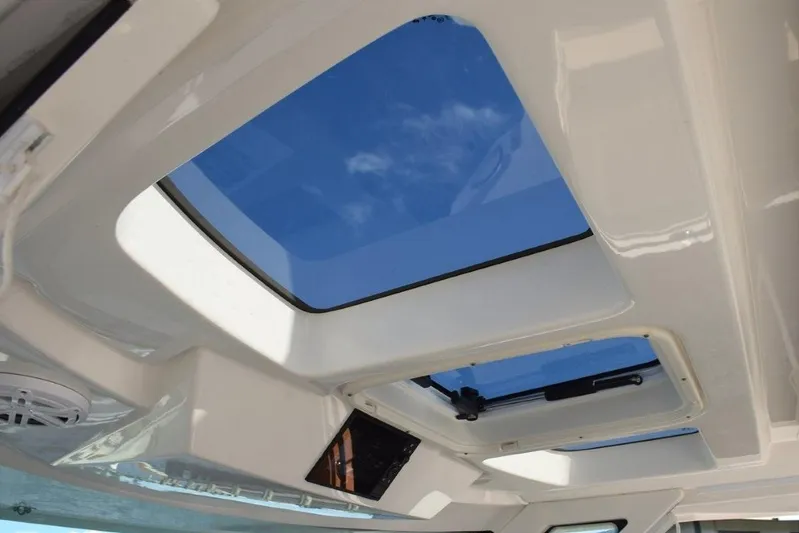 Diamond Pearl Yacht Photos Pics 2024 Tiara Yachts 38 LS opening skylights overhead of helm. Engine data screen in overhead panel.