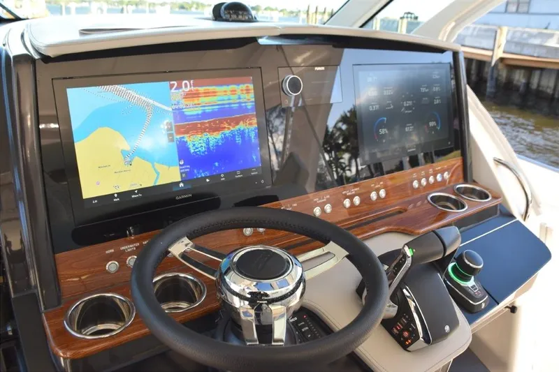 Diamond Pearl Yacht Photos Pics 2024 Tiara Yachts 38 LS helm with tiltable wheel, wood dash panel with drink holders, glovebox to the right.