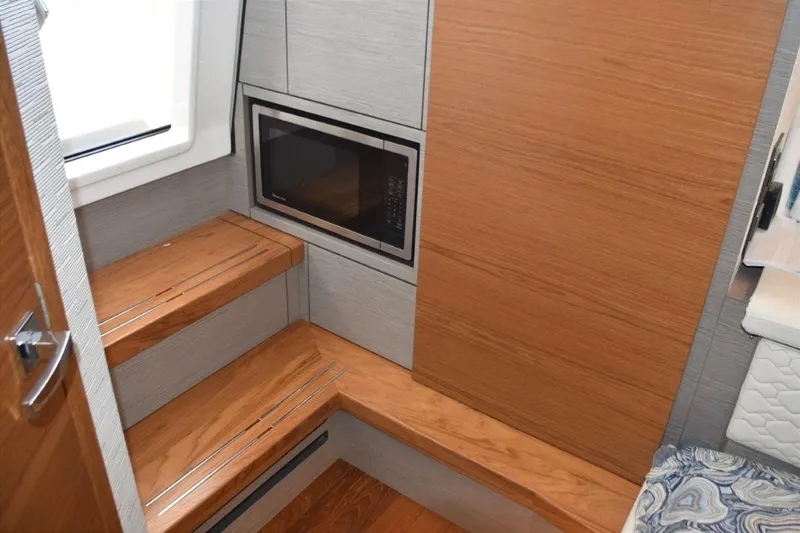 Diamond Pearl Yacht Photos Pics Wood cabin entry steps and sole. Microwave Oven - electrical panel behind door