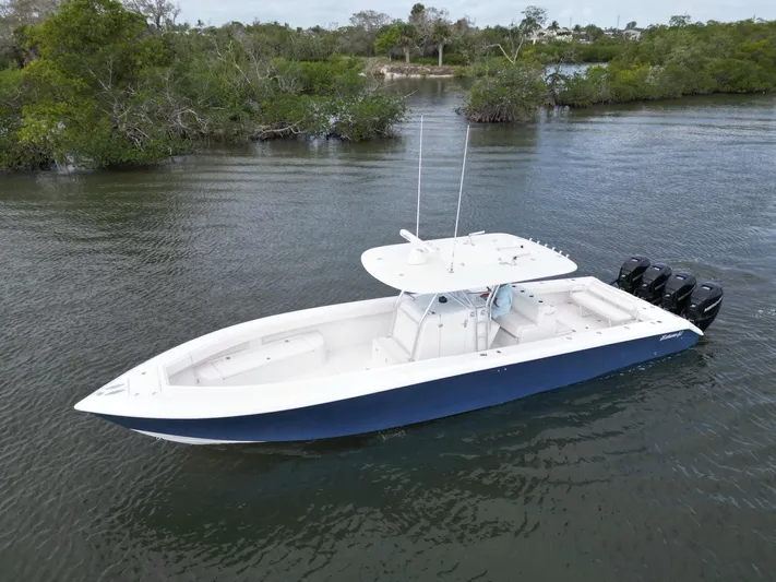  Yacht Photos Pics 2013 Bahama Open Fisherman boat with triple outboard engines on calm water.