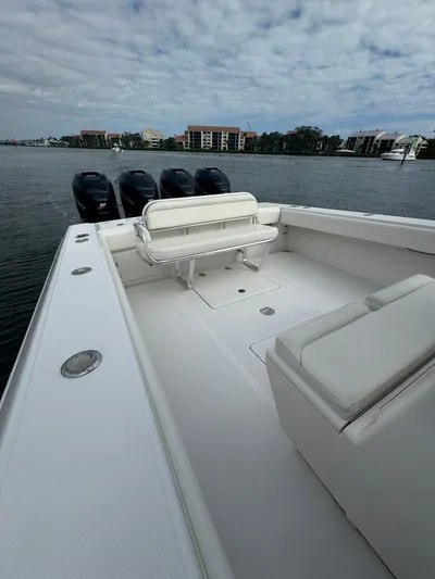  Yacht Photos Pics 2013 Bahama Open Fisherman boat with multiple outboard engines on a calm waterway.