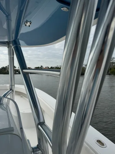  Yacht Photos Pics 2013 Bahama Open Fisherman boat with stainless steel railings on a calm waterway.
