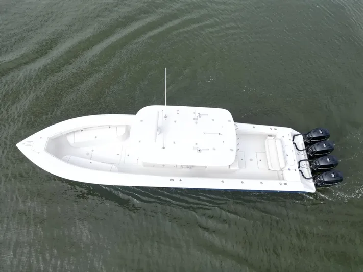  Yacht Photos Pics 2013 Bahama Open Fisherman boat with triple outboard engines on water.