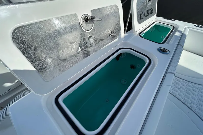  Yacht Photos Pics 2026 Contender 35 ST boat with open storage compartments and teal interior.