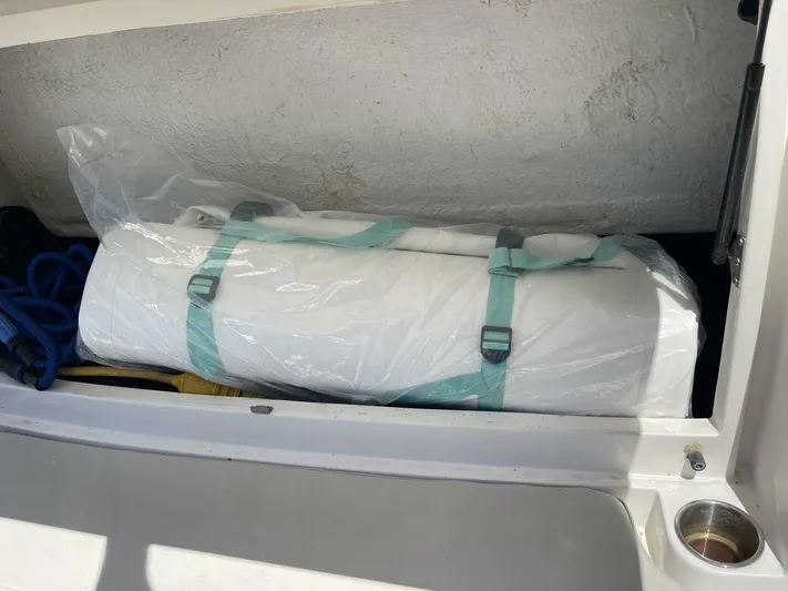  Yacht Photos Pics Storage compartment in a 2007 Rinker 350 Express Cruiser with secured rolled-up item.