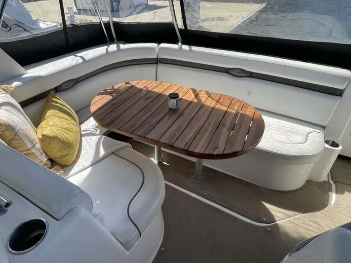  Yacht Photos Pics 2007 Rinker 350 Express Cruiser interior with wooden table and cushioned seating.