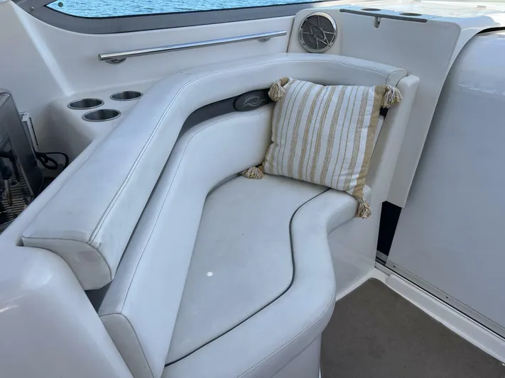  Yacht Photos Pics 2007 Rinker 350 Express Cruiser interior with white seating and striped cushion.