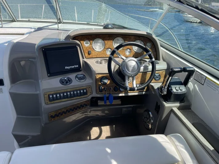  Yacht Photos Pics 2007 Rinker 350 Express Cruiser helm with steering wheel, controls, and navigation system.