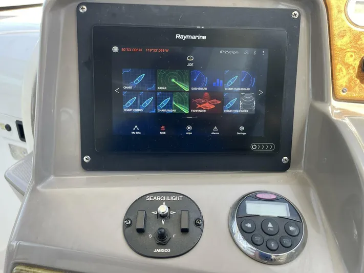  Yacht Photos Pics Raymarine navigation system on 2007 Rinker 350 Express Cruiser dashboard with searchlight controls.