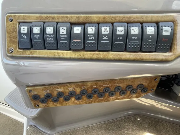  Yacht Photos Pics Control panel of a 2007 Rinker 350 Express Cruiser with labeled switches and buttons.