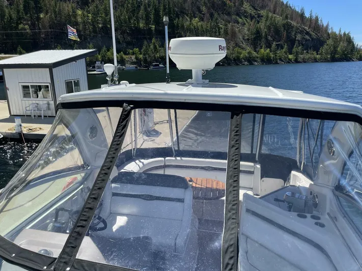  Yacht Photos Pics 2007 Rinker 350 Express Cruiser docked by a scenic lake with forested hills.