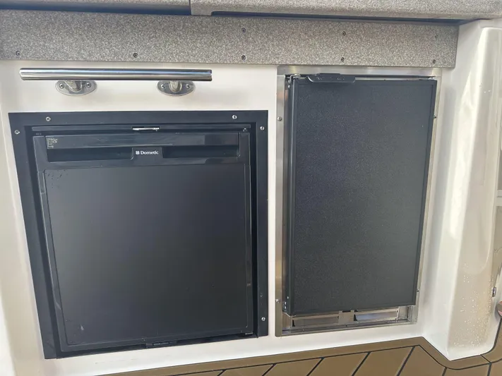  Yacht Photos Pics 2007 Rinker 350 Express Cruiser galley with built-in refrigerator and storage compartment.