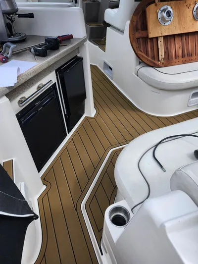  Yacht Photos Pics 2007 Rinker 350 Express Cruiser interior with wood flooring and compact kitchen area.