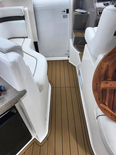  Yacht Photos Pics 2007 Rinker 350 Express Cruiser interior with white seating and wood-style flooring.