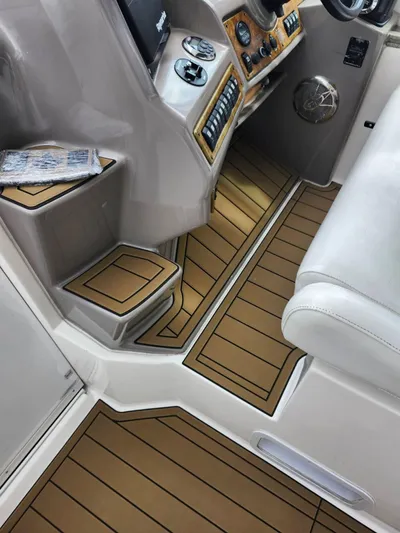 Yacht Photos Pics 2007 Rinker 350 Express Cruiser cockpit with wood-patterned flooring and modern controls.