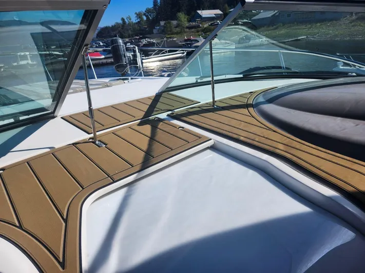  Yacht Photos Pics 2007 Rinker 350 Express Cruiser deck with open windshield, docked at marina.