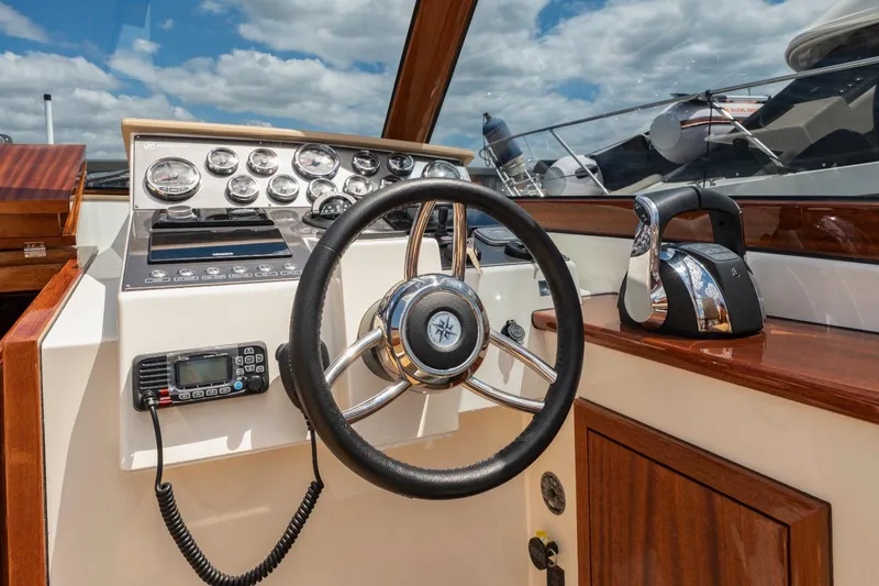  Yacht Photos Pics Vento V40 Retro Classic Open 2023 boat dashboard with steering wheel and control panel.