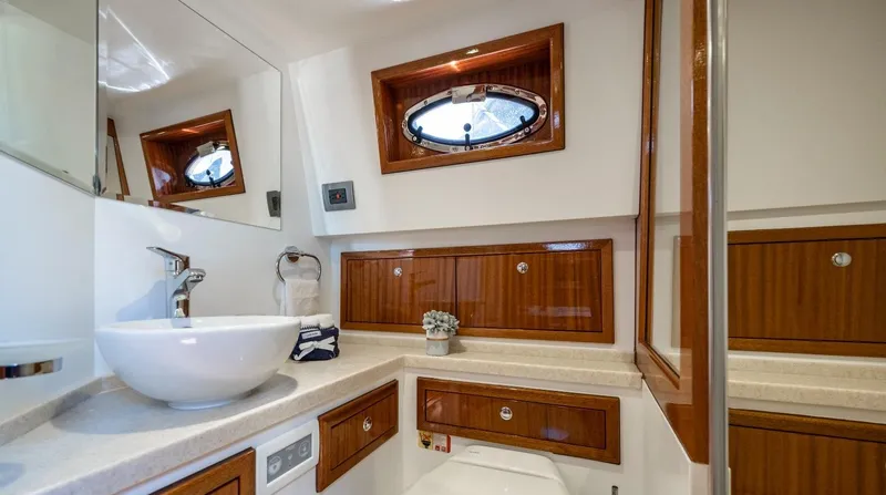  Yacht Photos Pics Elegant bathroom in 2023 Vento V40 Retro Classic Open yacht with wooden cabinets and modern fixtures.