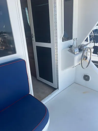  Yacht Photos Pics 1999 Viking 58 EB yacht interior with blue seating and helm station.