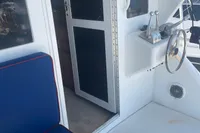 1999 Viking 58 EB yacht interior with blue seating and helm station.