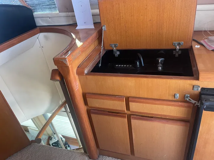  Yacht Photos Pics 1999 Viking 58 EB yacht interior with wooden cabinetry and built-in stove.
