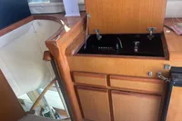 1999 Viking 58 EB yacht interior with wooden cabinetry and built-in stove.