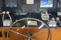 Boat helm of a 1999 Viking 58 EB with navigation screens and controls.