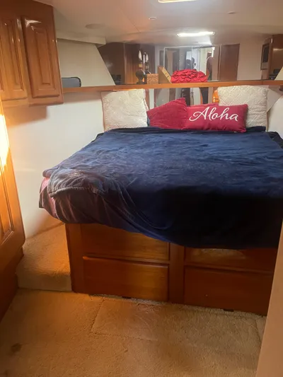  Yacht Photos Pics Cozy bedroom in 1999 Viking 58 EB yacht with plush bedding and "Aloha" pillow.