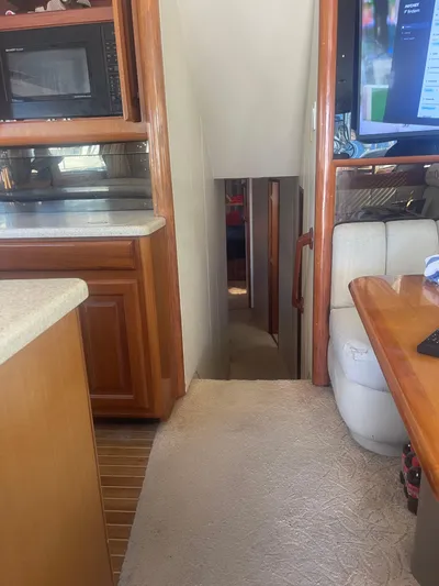  Yacht Photos Pics Interior of a 1999 Viking 58 EB yacht, featuring a cozy hallway and wooden cabinetry.