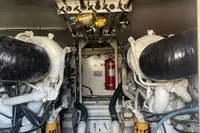 Engine room of 1999 Viking 58 EB yacht with fishing rods and equipment.