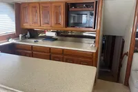 1999 Viking 58 EB yacht kitchen with wooden cabinets and microwave.