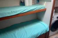 Bunk beds with teal sheets in a 1999 Viking 58 EB yacht interior.