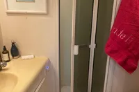 Bathroom interior of a 1999 Viking 58 EB yacht with shower and sink.