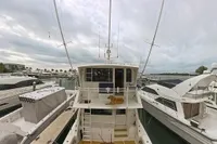1999 Viking 58 yacht docked at marina, view from above, cloudy sky.