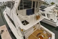 1999 Viking 58 yacht docked, featuring spacious deck and modern design.