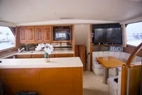 Interior of 1999 Viking 58 yacht with kitchen and dining area.