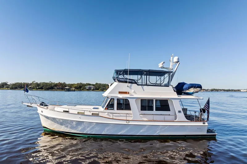 Draagen Yacht Photos Pics 2006 Grand Banks Europa 47 yacht on calm water under clear blue sky.