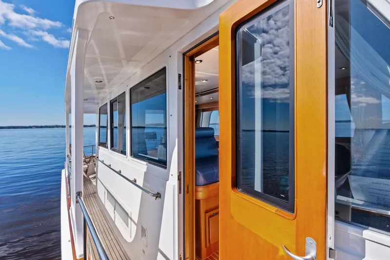 Draagen Yacht Photos Pics 2006 Grand Banks Europa 47 yacht deck with wooden door and ocean view.