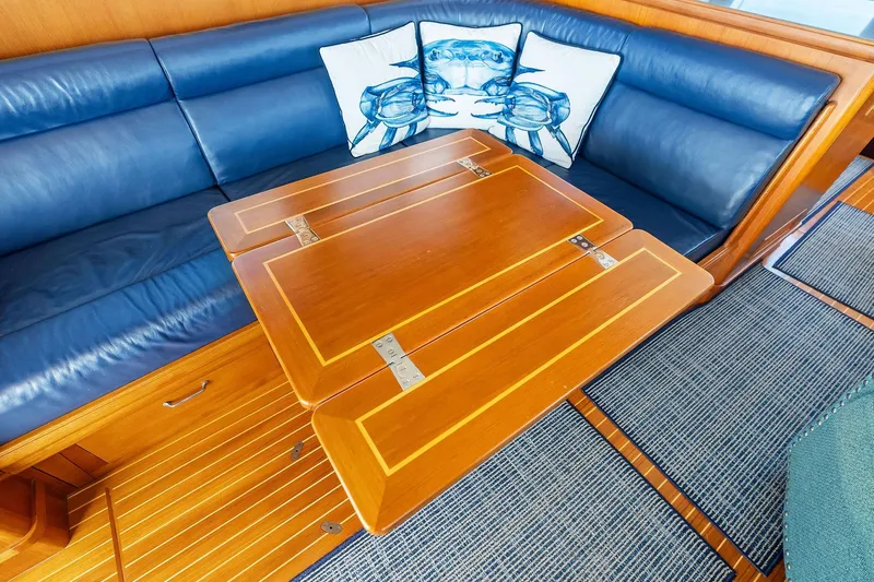 Draagen Yacht Photos Pics Interior of 2006 Grand Banks Europa 47 with blue seating and wooden table.