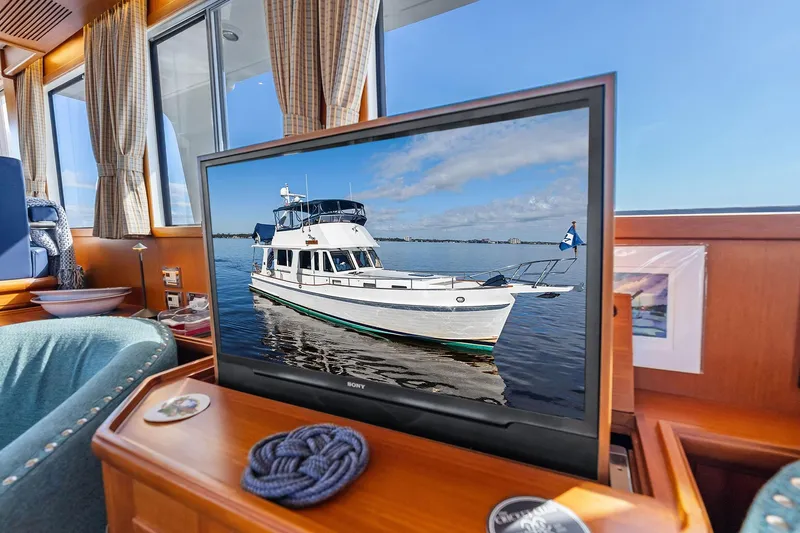 Draagen Yacht Photos Pics Interior of a 2006 Grand Banks Europa 47 yacht with a TV displaying the boat.