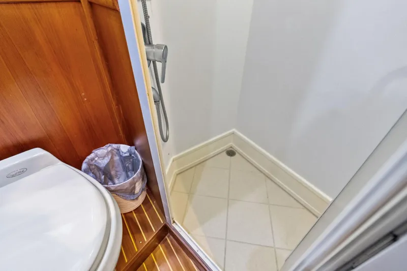 Draagen Yacht Photos Pics Bathroom interior of 2006 Grand Banks Europa 47 yacht, featuring shower and toilet.