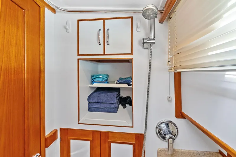 Draagen Yacht Photos Pics Bathroom interior of 2006 Grand Banks Europa 47 yacht with wooden cabinetry and shower.