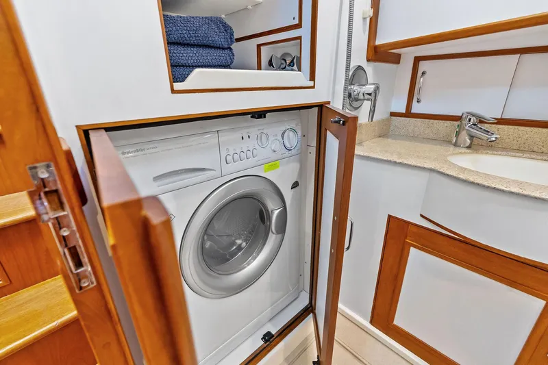 Draagen Yacht Photos Pics Laundry area with washer in 2006 Grand Banks Europa 47 yacht bathroom.