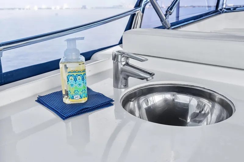 Draagen Yacht Photos Pics Stainless steel sink and soap dispenser on 2006 Grand Banks Europa 47 yacht deck.